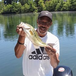 An angler holding a 13-inch fish in MO