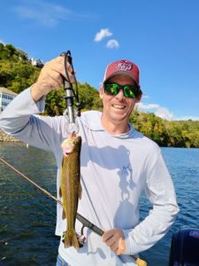 Angler with a rainbow trout in Branson