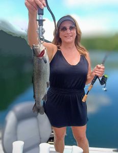 Angler holding a rainbow trout in Branson
