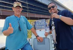A photo of two people fishing for a coho salmon in Branson.