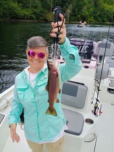 A rainbow trout caught by two people in Branson