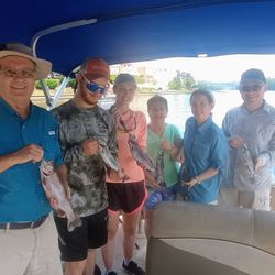 Three anglers holding their catch in Branson