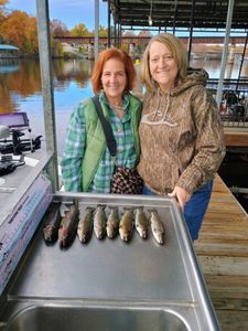Two people fishing for rainbow trout in Branson