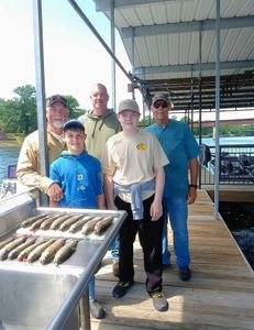 Five people enjoying a fishing trip in Branson