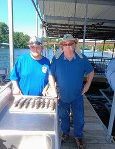 Two people fishing in Branson