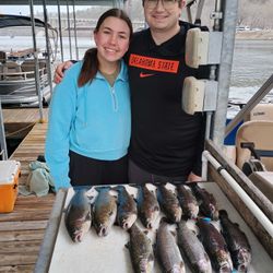 Two anglers holding five rainbow trout in Missouri