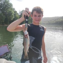 Fisherman with a rainbow trout in Branson