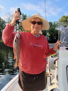 Angler catching a rainbow trout in Branson