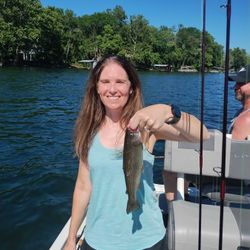 Angler holding a rainbow trout in Branson