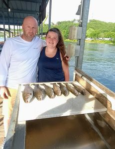 Two anglers fishing in Missouri with two fish