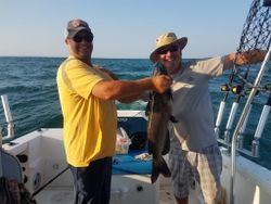 A couple fishing at a lakeside location