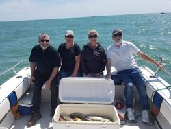 Four people enjoying a lakeside fishing trip in Marblehead
