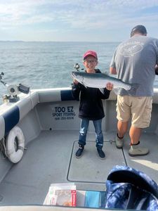Young angler with a shiny Coho—awesome!