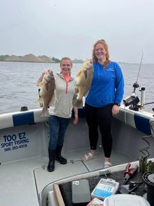 Two anglers fishing in Michigan with two big fish