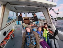 Group of 5 people enjoying a fishing cruise in Michigan