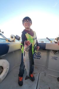 Angler with a large rainbow trout caught in Muskegon