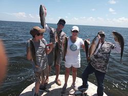 6 fishing enthusiasts enjoying a day on the waters of South Padre Island