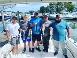 A group of 5 people fishing at the lakeside in Marblehead