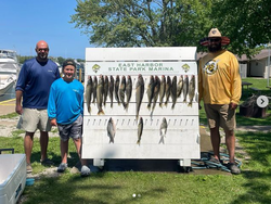 Three people fishing at the lakeside in Marblehead