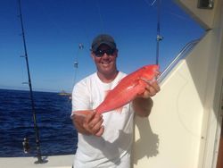 Angler posing with a 13-inch catch in Kailua-Kona