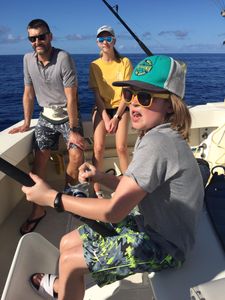 Three people fishing in the ocean at Kailua-Kona