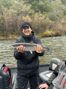 Angler holding a 22-inch fish in the scenic Port Orford, Oregon