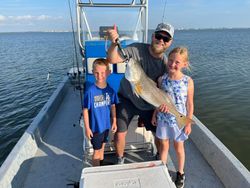 Angler holding a large redfish caught in Rockport