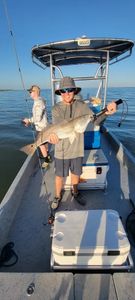 Two people fishing for a big 40-inch fish in TX