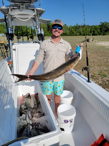 Angler with a fishing rod at Oak Island