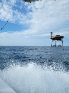 Fishing boat wake with offshore platform structure in Oak Island NC waters