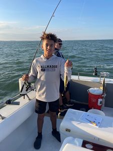 Two anglers holding a freshly caught fish in Port Clinton