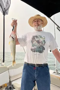 A person holding a pollock fish that is 17 inches long in Lakeside Marblehead