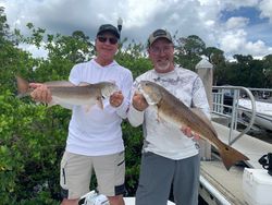 Two anglers reeling in big fish in Florida