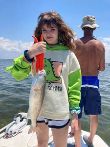 Lone fisherman landing a 17-inch catch in Florida