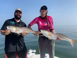 Two redfish, 24 inches long, caught while fishing in FL