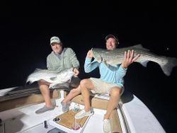 Two anglers holding big fish caught in Wells