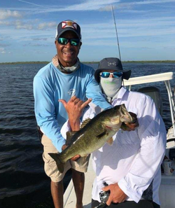 A fisherman holding a 16-inch fish in Kissimmee