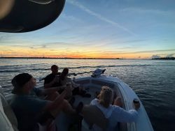 Fishing boat on water at sunset in Port Orange FL with group enjoying evening fishing trip