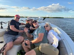 Fishing boat on calm water in Port Orange FL with four people enjoying a day on the water