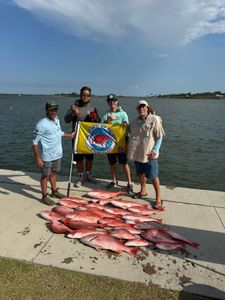 Red snapper fishing catch displayed on dock in Port Orange FL with fishing flag