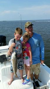 Three anglers enjoying a fishing cruise in FL