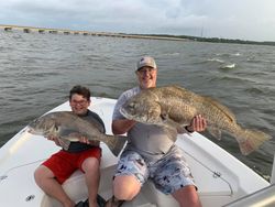 Two anglers catching black drum fish in Apalachicola