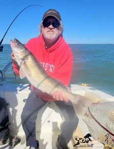 Angler with big fish by lakeside in Lakeside Marblehead
