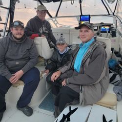 Four people enjoying a day of fishing at the lakeside in Marblehead