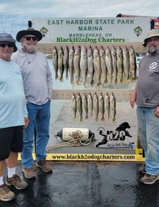 Three people enjoying a fishing trip at the lakeside in Marblehead