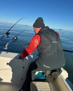 Person fishing at lakeside in Marblehead