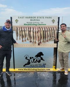 Two people standing by the lakeside in Marblehead, fishing