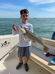 Single fisherman with large catch at lakeside location