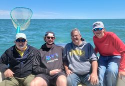Four people enjoying a lakeside fishing trip at Lakeside Marblehead