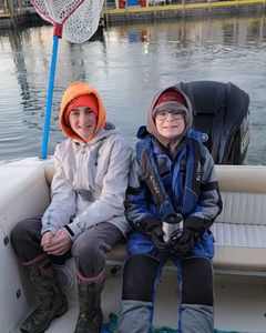 Two people fishing at lakeside Marblehead